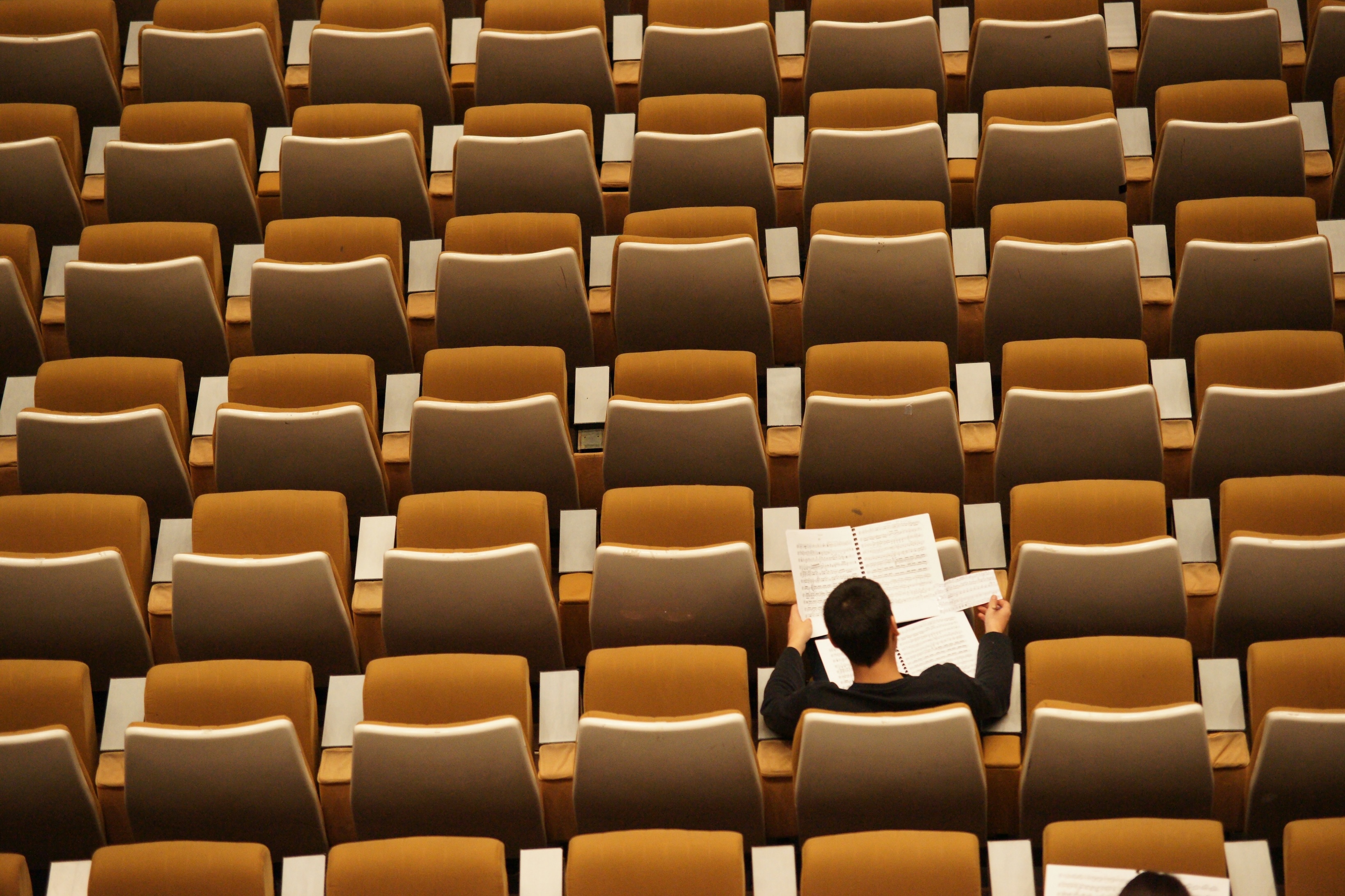 Man sitting in empty auditorium